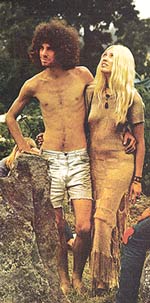 Shirtless young man with bushy hair and his long-haired hippie girlfiend